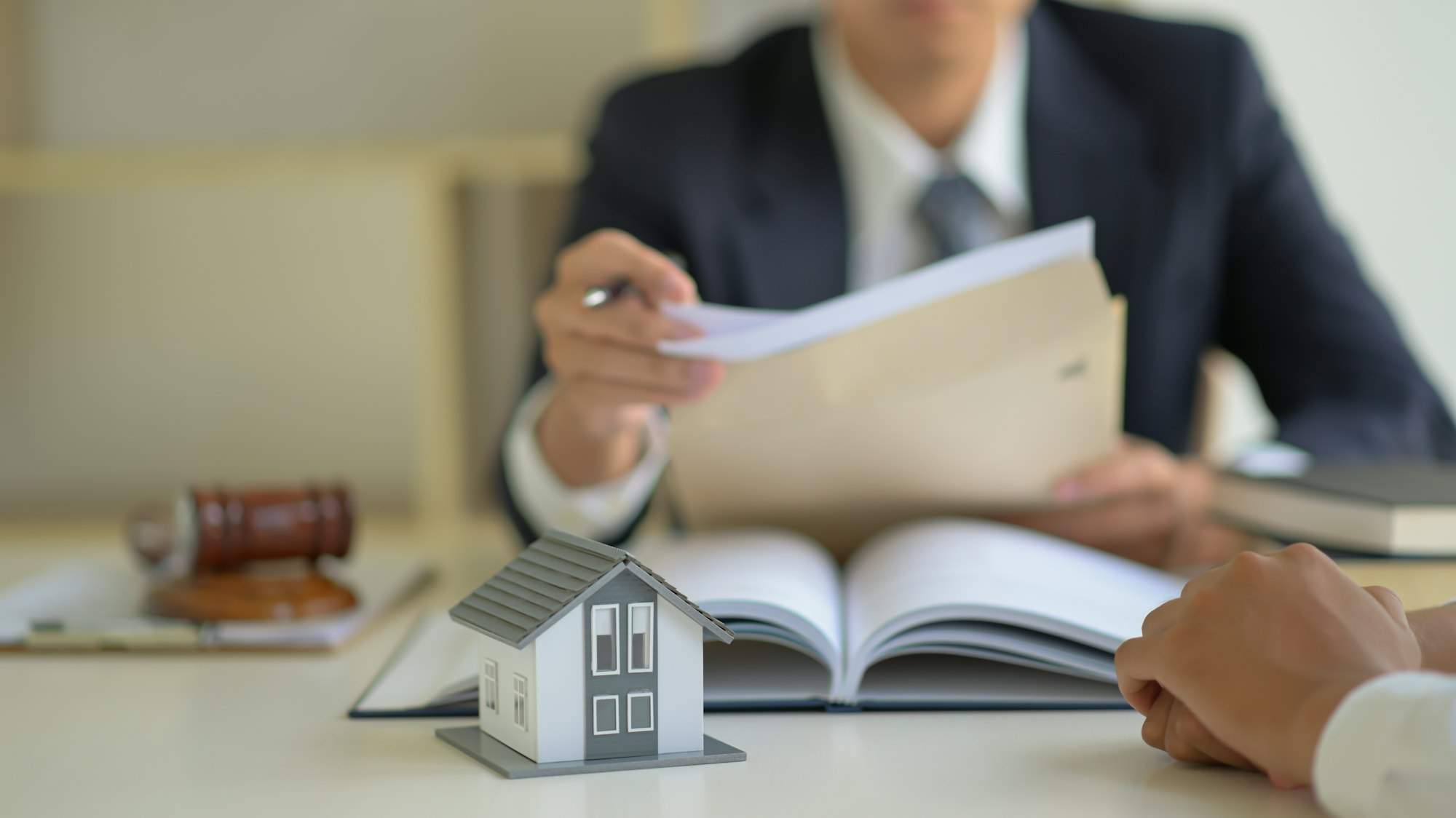 The lawyer is consulting clients about the house purchase contract.